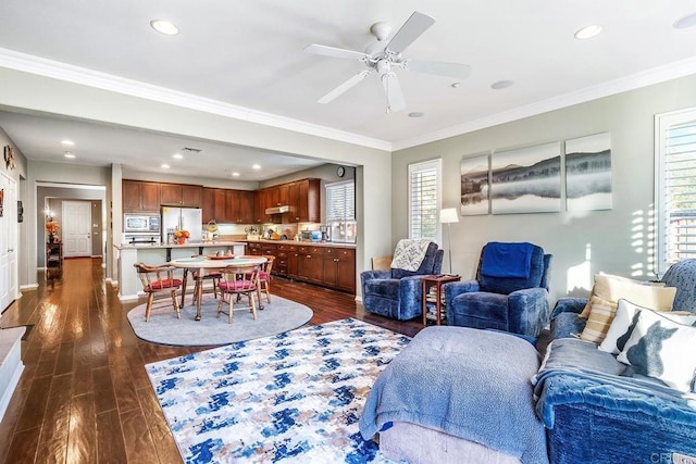 living room with ceiling fan, dark hardwood / wood-style flooring, and ornamental molding