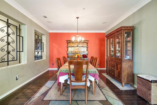 dining space with dark hardwood / wood-style floors, an inviting chandelier, and ornamental molding