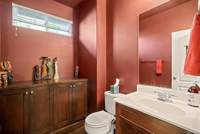 bathroom featuring toilet and vanity