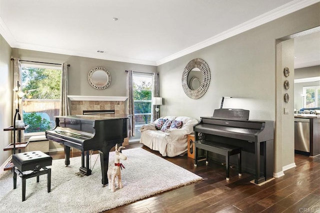 living area featuring dark wood-type flooring, a wealth of natural light, and ornamental molding