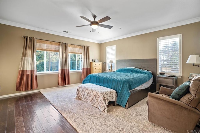 bedroom with ceiling fan, ornamental molding, and multiple windows