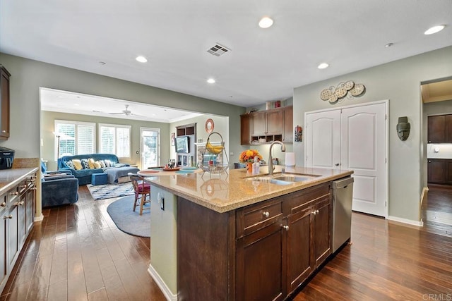 kitchen with a center island with sink, ceiling fan, dark hardwood / wood-style floors, dishwasher, and sink