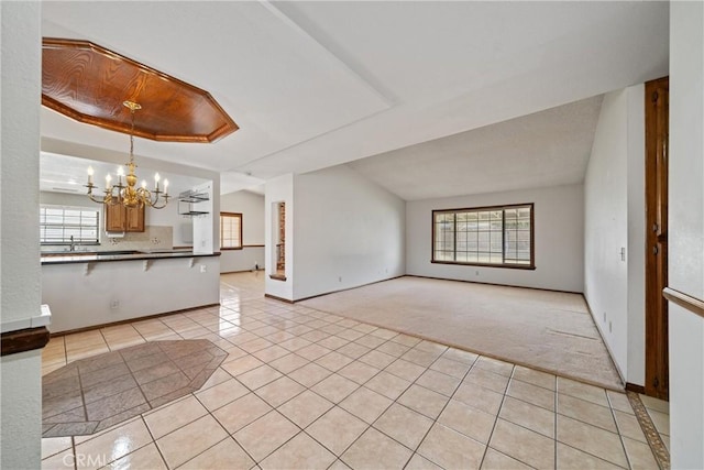 unfurnished living room with light tile patterned floors and a notable chandelier