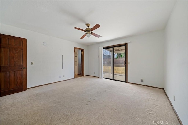 spare room featuring ceiling fan and light colored carpet