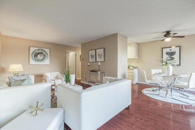 living room with ceiling fan and hardwood / wood-style flooring