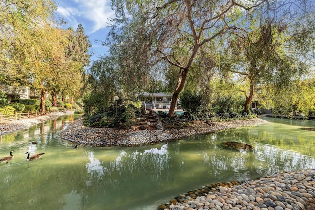 surrounding community featuring a water view