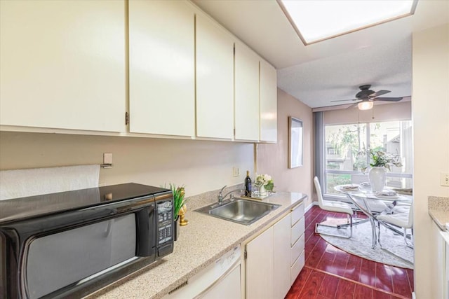 kitchen with ceiling fan, sink, and white cabinetry