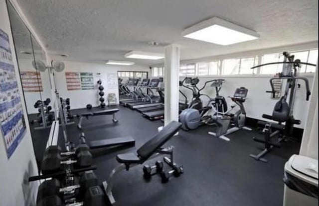 exercise room featuring a textured ceiling