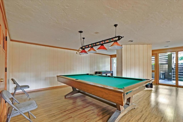 playroom featuring billiards, wood walls, and light wood-type flooring