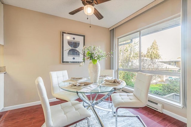 dining room with ceiling fan, dark wood-type flooring, and a baseboard radiator