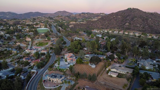 aerial view at dusk featuring a mountain view