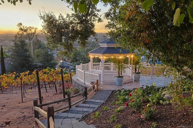 yard at dusk featuring a gazebo