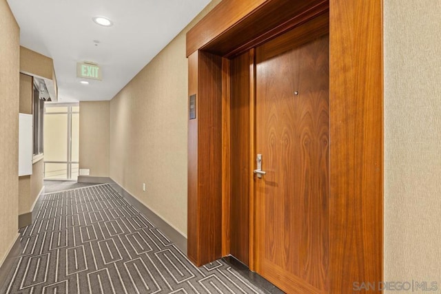 hallway featuring a wall of windows