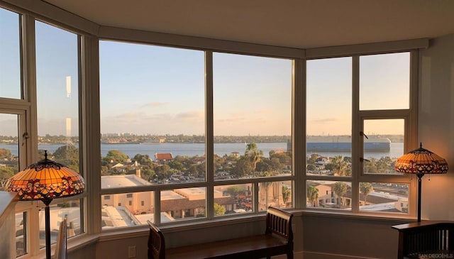 unfurnished sunroom featuring a water view