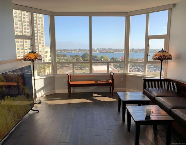 sunroom featuring plenty of natural light and a water view