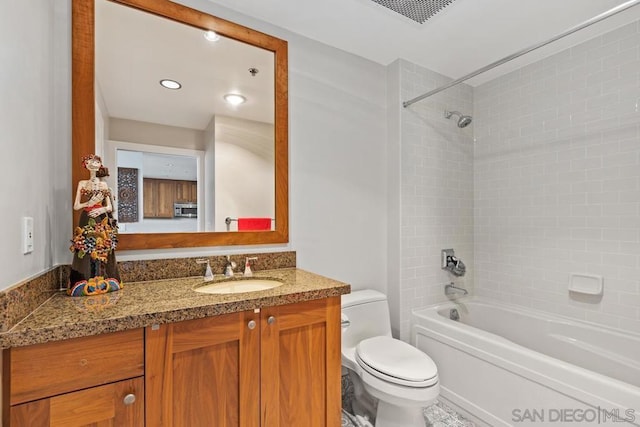 full bathroom with toilet, tiled shower / bath, and vanity