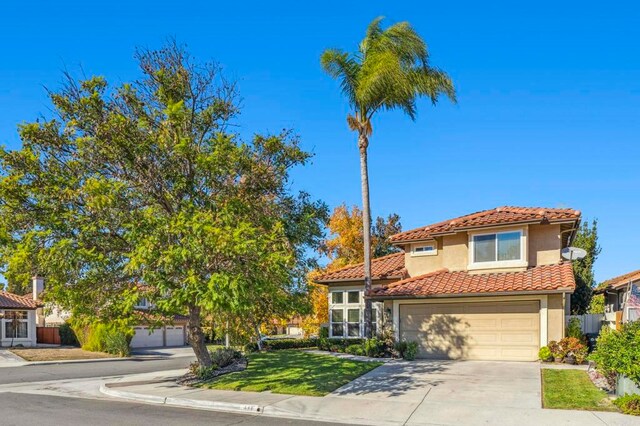 mediterranean / spanish-style home featuring a garage