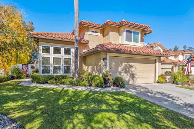 mediterranean / spanish home featuring a front yard and a garage