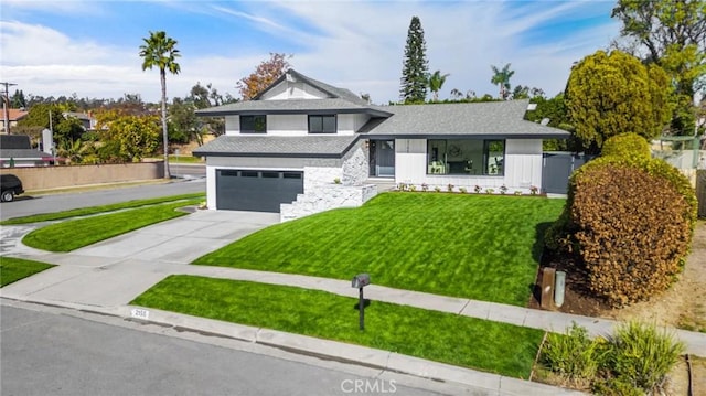 view of front of property with a garage and a front yard