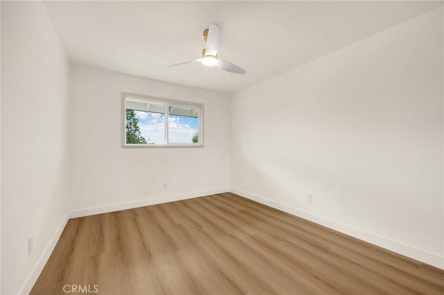 spare room featuring ceiling fan and light hardwood / wood-style floors