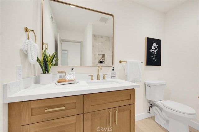 bathroom with toilet and vanity