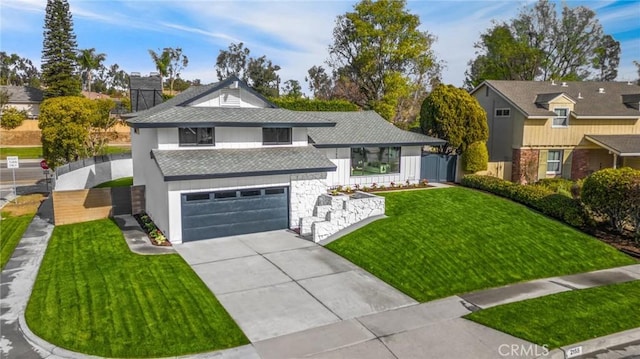 front of property with a front lawn and a garage