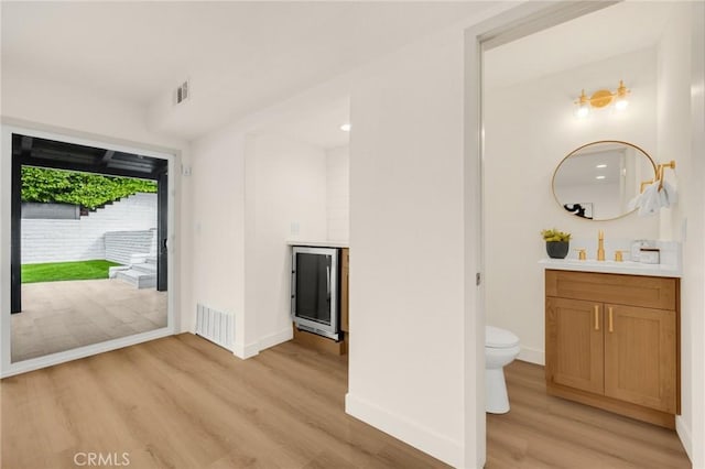 interior space featuring toilet, hardwood / wood-style flooring, and vanity