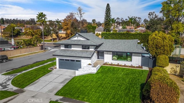 view of front facade with a front yard and a garage