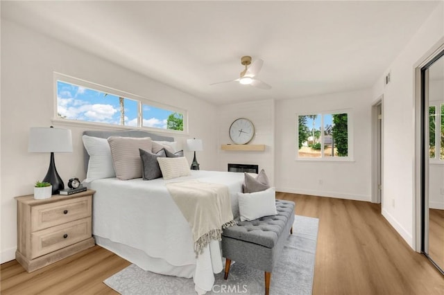 bedroom with ceiling fan and light hardwood / wood-style floors