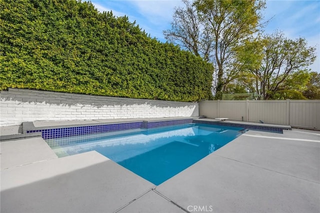 view of pool featuring a diving board