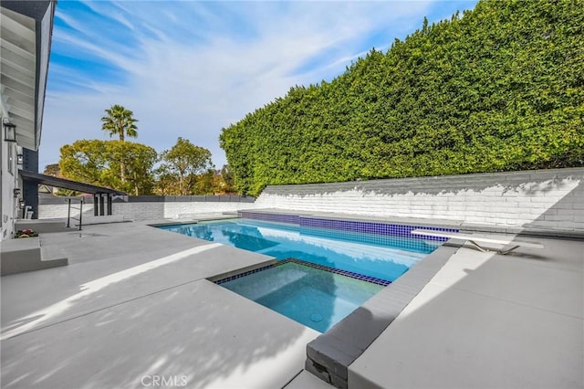 view of pool with an in ground hot tub and a patio