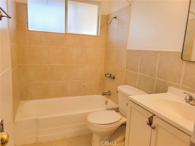 full bathroom with tile patterned flooring, tile walls, tiled shower / bath, toilet, and vanity