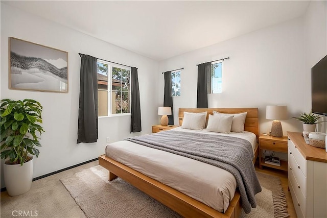 bedroom with light colored carpet