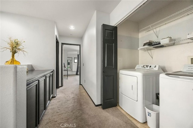 washroom with independent washer and dryer and light carpet