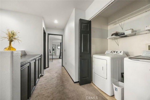 laundry room with laundry area, light carpet, and washer and clothes dryer