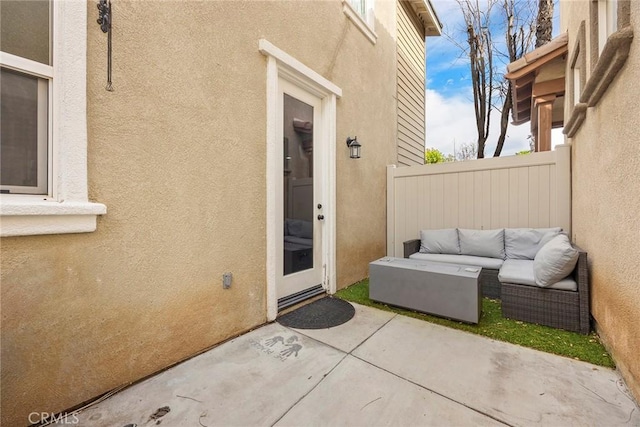 view of patio featuring an outdoor living space and fence