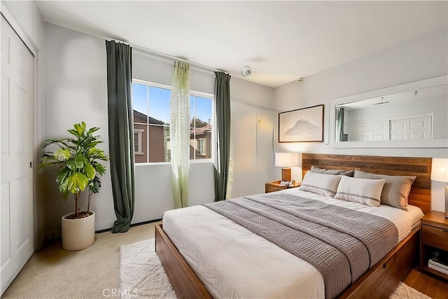 bedroom featuring light carpet