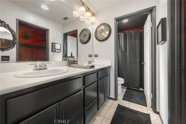 full bathroom with double vanity, visible vents, toilet, and a sink