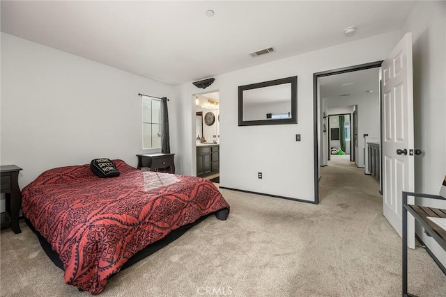 bedroom featuring baseboards, light colored carpet, visible vents, and connected bathroom