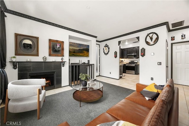 living area with light tile patterned floors, visible vents, a fireplace, and crown molding