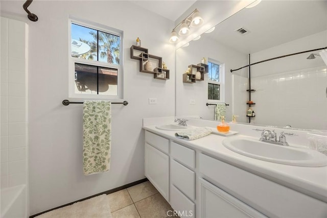 full bath featuring a sink, visible vents, double vanity, and tile patterned flooring