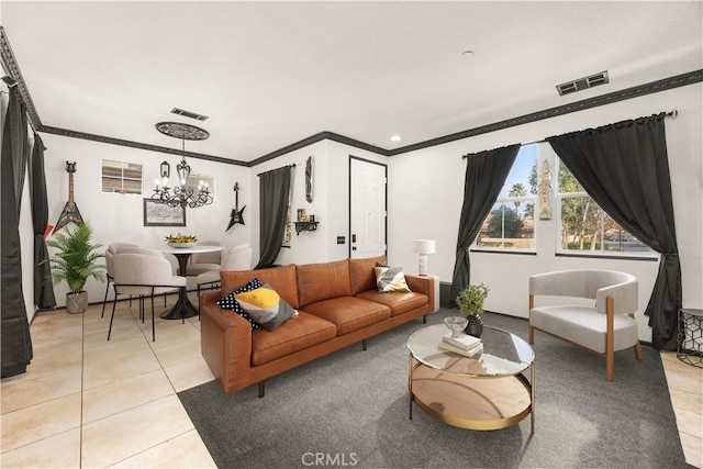 living area with light tile patterned floors, visible vents, a notable chandelier, and ornamental molding