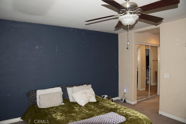 carpeted bedroom featuring ceiling fan and a closet