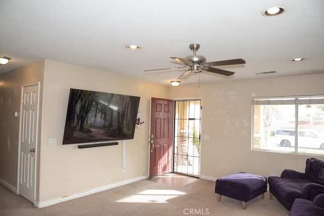 carpeted living room featuring ceiling fan