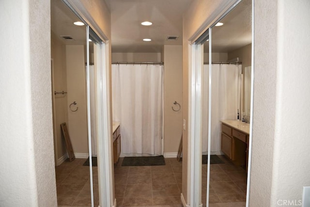 bathroom with vanity and tile patterned flooring