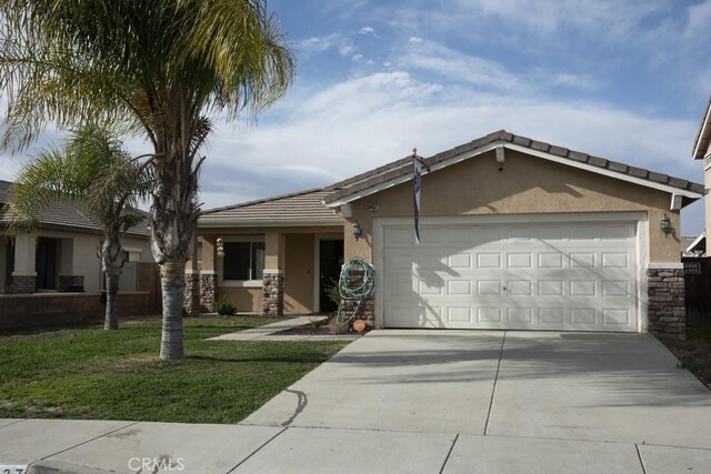 ranch-style house with a garage and a front lawn