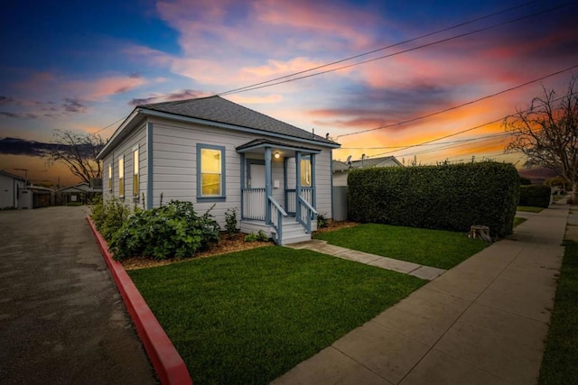 bungalow-style home with a lawn