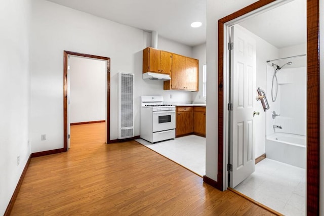 kitchen with white stove and light wood-type flooring