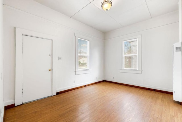 unfurnished room with wood-type flooring