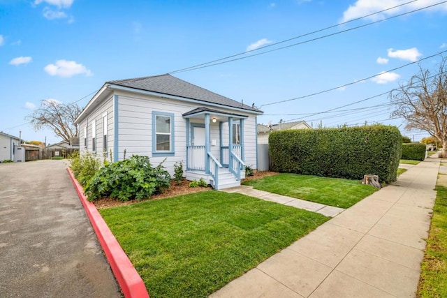 bungalow-style home featuring a front yard